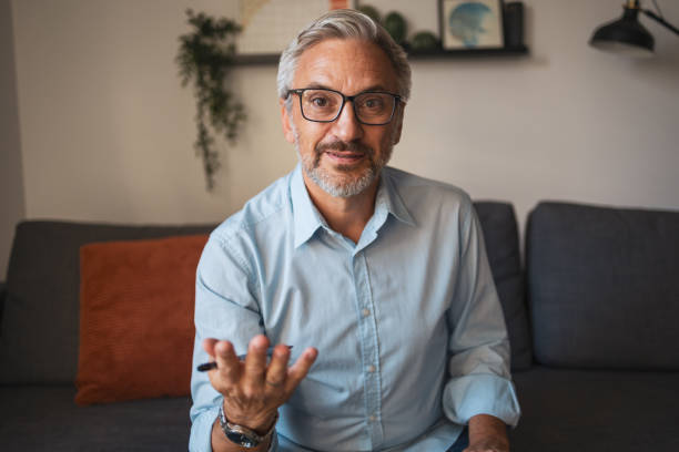 istock Mature man having a video call. He is talking to the camera 2192440765