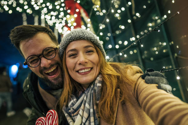 couple taking selfie on street during holidays