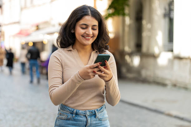 istock Woman using smartphone texting social media messages looking for a way on navigator map city street 2192449280