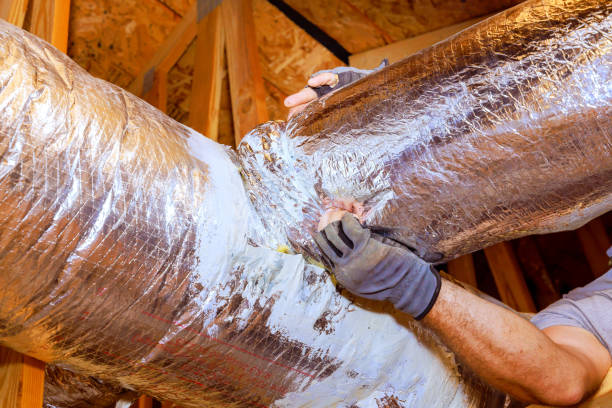 istock Hands working on sealing ductwork in a residential attic during home maintenance task 2192449588