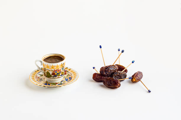 Luxury Dried Date Fruits in the stylish,golden bowl on the white background with coffee.