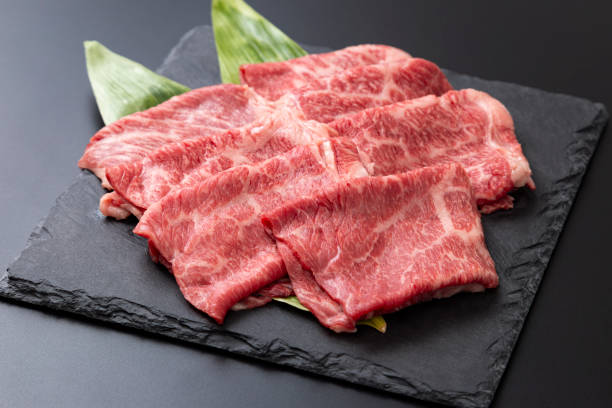 Beef shoulder loin for sukiyaki on a black background