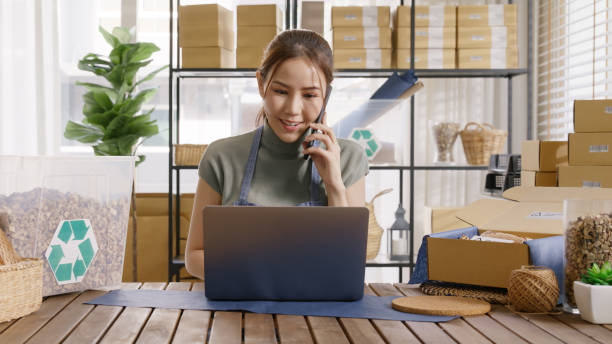 istock Save the planet earth Eco friendly box in net zero waste store asian seller digital retail office SDGs shop. ESG Small SME owner asia people happy woman vendor smile holding mobile looking at camera. 2192452914