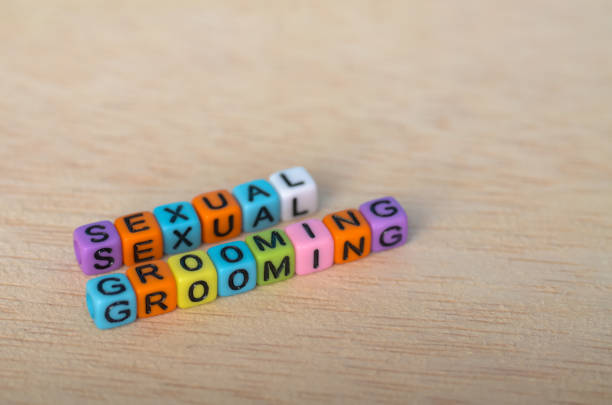 istock Awareness Message 'SEXUAL GROOMING' in Bright Beads on Wooden Background 2192454548