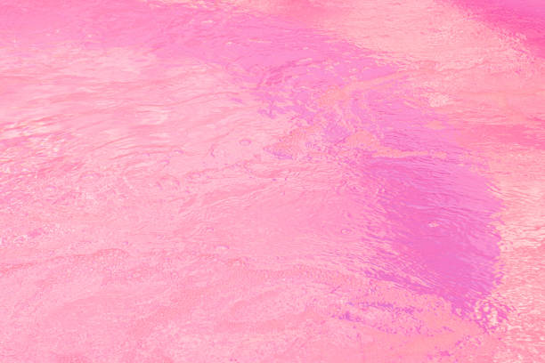 Calm, pink water surface with subtle waves and a dreamy, ethereal quality
