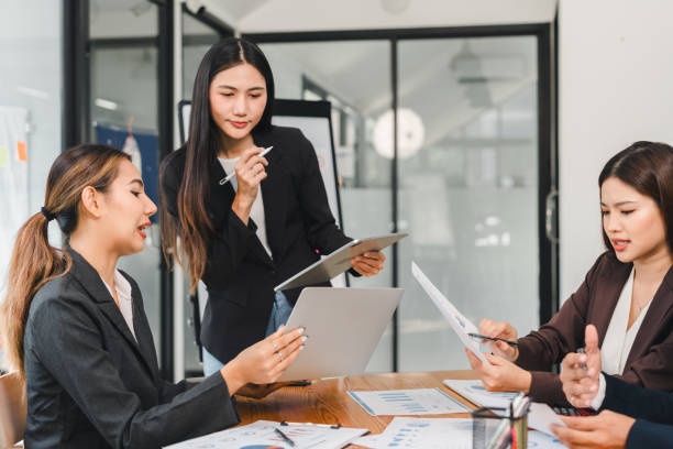 istock Professional women collaborating in modern office setting, discussing strategies and analyzing data on digital devices. Their focused expressions reflect teamwork and innovation 2192455881