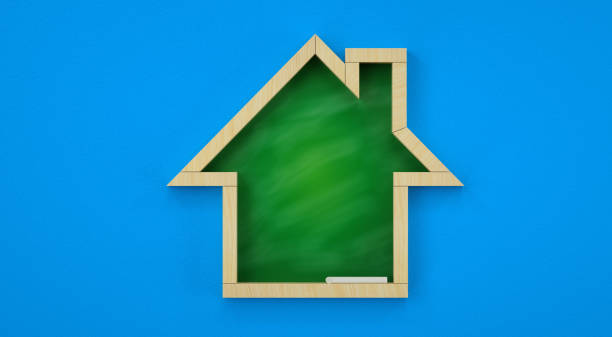 istock Wooden house-shaped chalkboard with green surface and light wood frame. Blue background, minimalist design for education and real estate learning. 3D effect, clean lines, bright colors, and studio lighting. 3D render. 2192458502