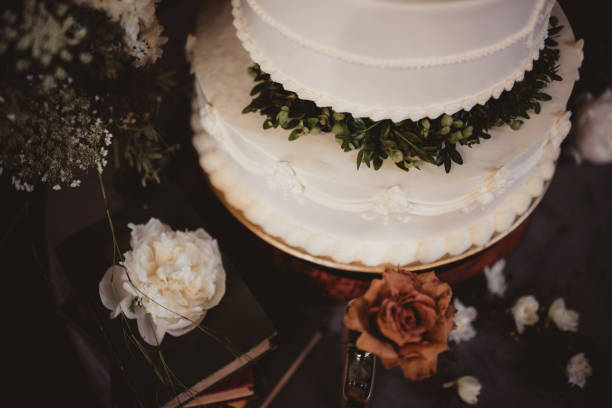 Layered wedding cake with white frosting and flowers