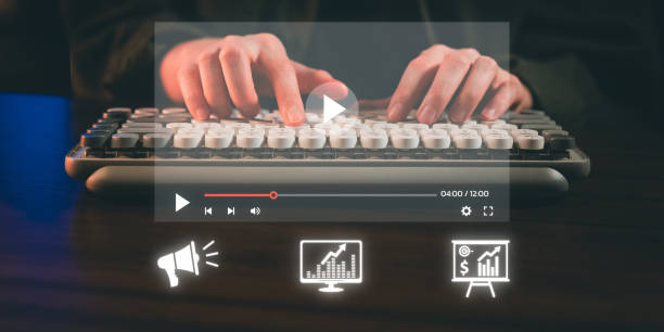 istock Hands typing on a keyboard with a video player interface and glowing analytics icons overlay, symbolizing content creation and data analysis 2192461304