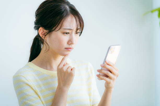 A woman operating a smartphone in the room