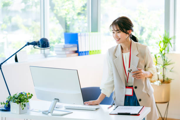 istock Business woman with smartphone in office 2192462044