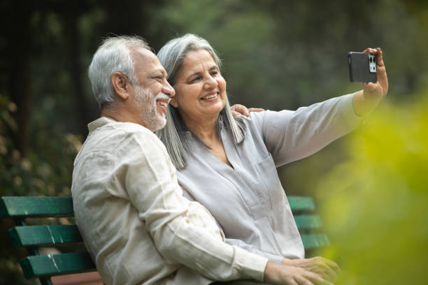 istock Senior couple taking selfie over mobile phone in park 2192462211