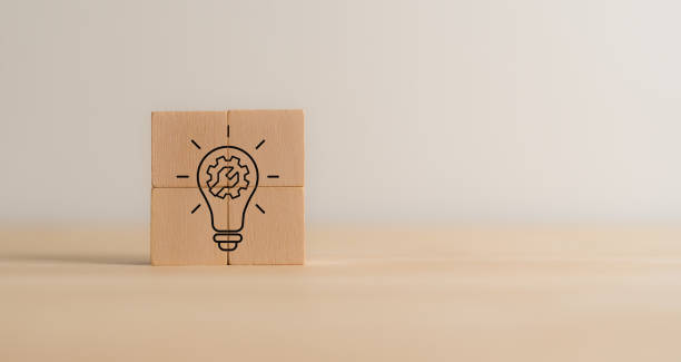 istock Business solutions concept. Wooden blocks combined to form a lightbulb icon with a gear inside, symbolizing creativity, innovation, problem-solving, business strategy and technology driven solutions. 2192462598