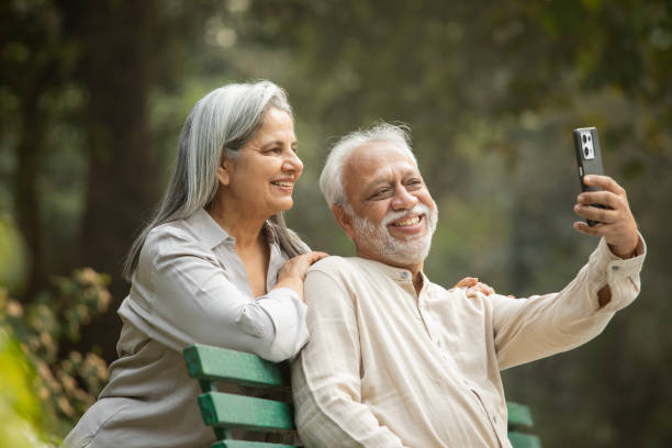 istock Senior couple taking selfie over mobile phone in park 2192463688