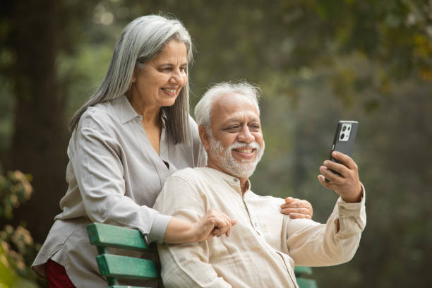 istock Senior couple taking selfie over mobile phone in park 2192463698
