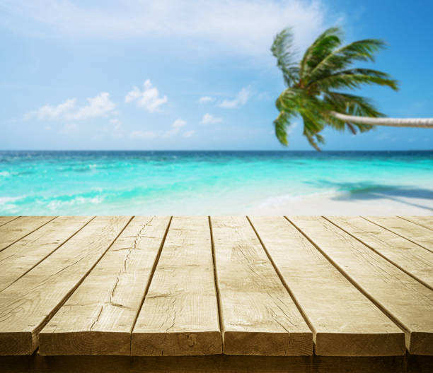 istock Empty wooden table top with beautiful tropical turquoise sea and coconut palm tree background 2192465204