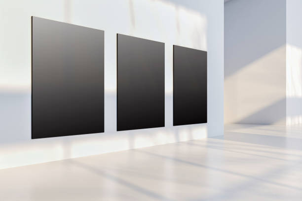 istock Blank gallery with three black canvases on white wall, illuminated by soft natural light, modern interior design. 3D Rendering 2192466462