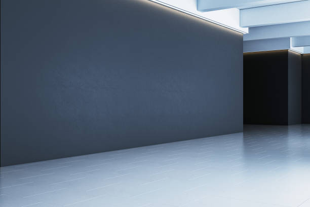 istock Minimalistic gallery interior with dark wall and clean flooring illuminated by modern lights. 3D Rendering 2192466466