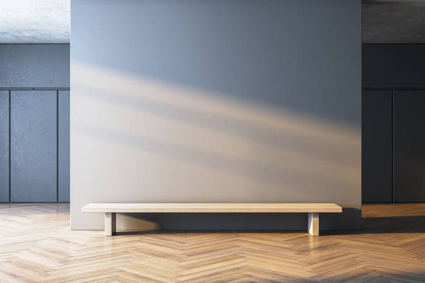 istock Modern interior with empty wall and wooden bench in clean minimalist room with sunlight streaming through. 3D Rendering 2192466470