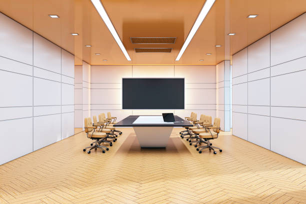 istock Modern conference room interior with a sleek desk, beige chairs, and a large presentation screen on a wooden floor background. 3D Rendering 2192466534