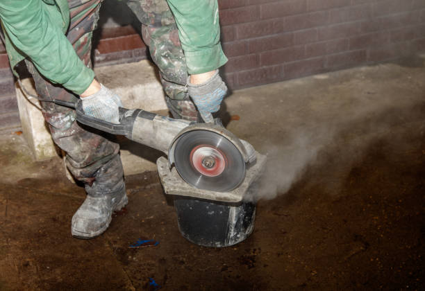 istock A man is using a power tool to cut a hole in a concrete block 2192467796