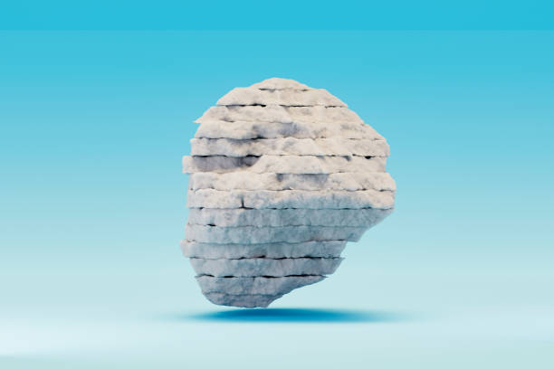 A serene winter scene featuring a snow-covered rock set against a cold blue background. This minimalist and tranquil design captures the essence of winter, perfect for seasonal, nature, or holiday-themed projects. Digitally generated image. 3d render.