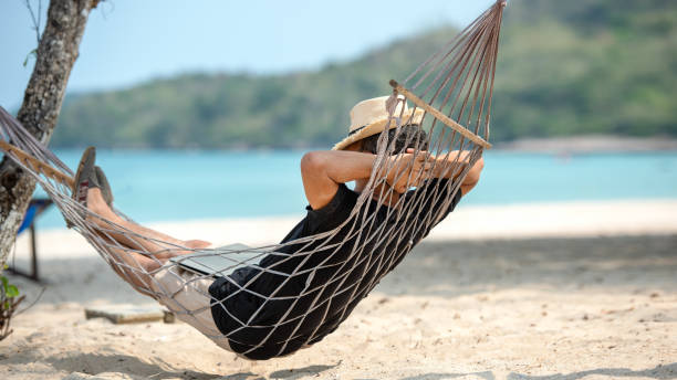 istock Lifestyle freelance man relax and sleeping on the hammock after using laptop working and relax on the beach. 2192470824