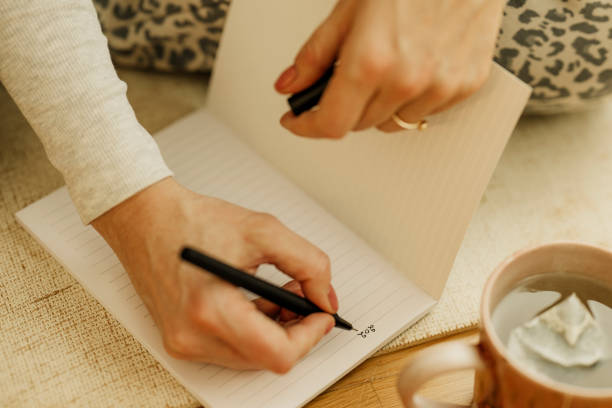 istock Woman planning writing with pen in notebook at home ready for new year 2192472147
