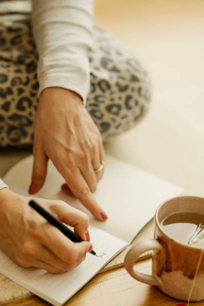 istock Woman planning writing with pen in notebook at home ready for new year 2192472162