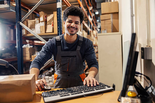 istock Portrait of interracial warehouseman using computer at dropshipping company and handling orders. 2192476123