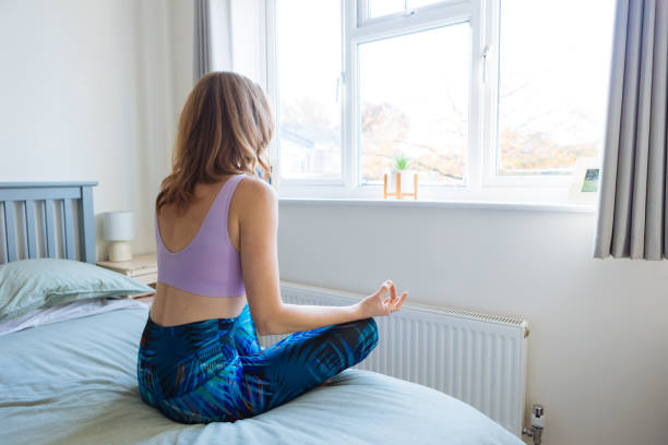 istock Beautiful woman meditating at home 2192477481