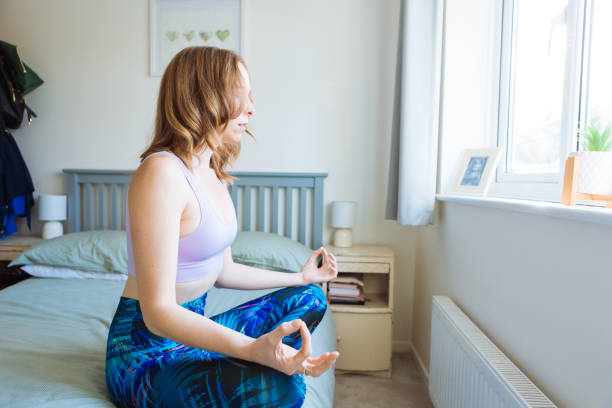 istock Beautiful woman meditating at home 2192477500