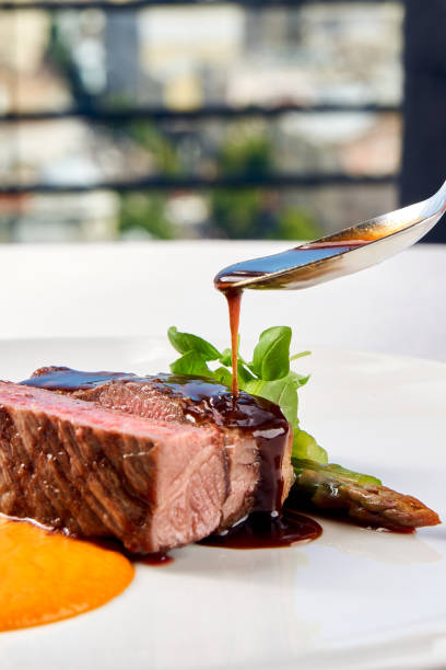 istock A gourmet dish featuring a perfectly cooked steak, served with a side of creamy mashed potatoes and a vibrant green vegetable. 2192478122