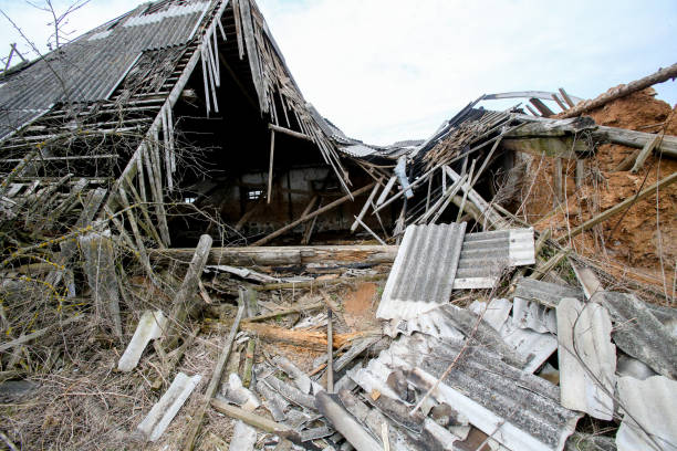 Collapsed old abandoned farm building after a fire