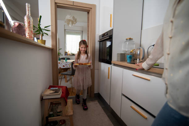 istock Young girl holding a pastry plate in a bright home kitchen 2192484835