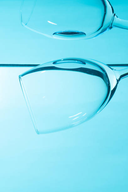istock Glass in water  isolated on blue background. 2192486693