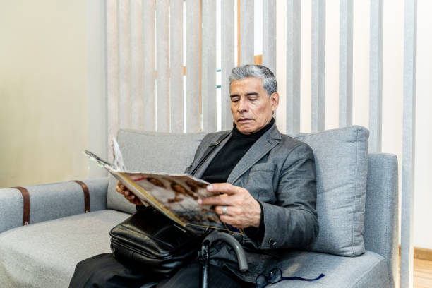 istock Senior man reading on a waiting room 2192487044