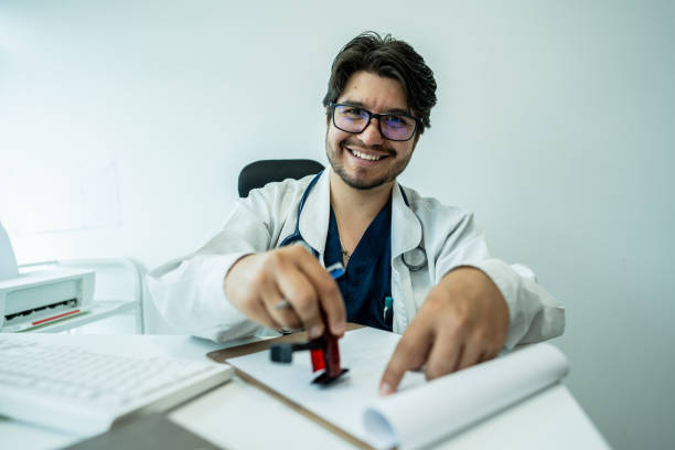 istock Portrait of a doctor stamping documents on a doctor's office 2192487167
