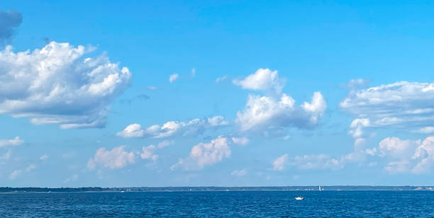 istock Calm Ocean View With Fluffy Clouds Under a Clear Blue Sky During Daytime 2192487640