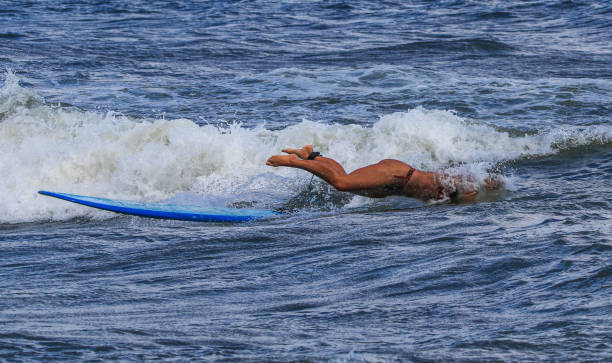 istock Surfer Performing a Dramatic Wipeout on a Sunny Day at the Beach 2192487725
