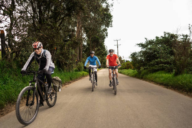 istock Cyclist friends riding bikes along the road 2192488501