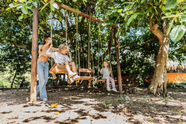 Siblings on swing at the recreational park