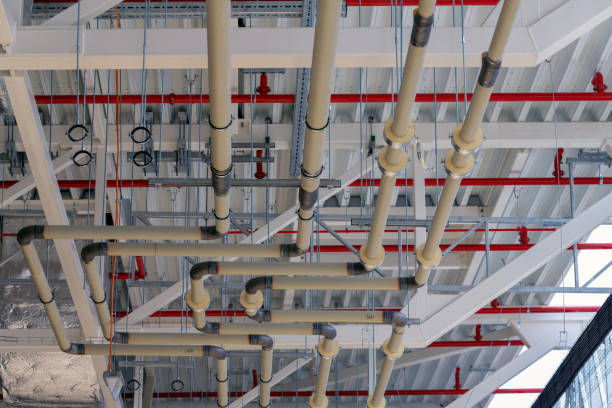 Miscellaneous industrial piping, cabling, mechanical and electrical installations inside manufacturing plant during construction works