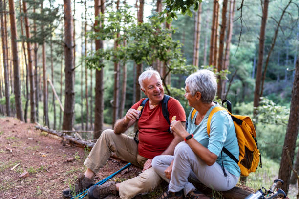 istock Active senior couple in nature resting in the forest after hiking. 2192489395