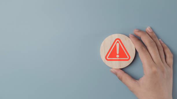 istock Red Flag Alert in wood label. Warning Icon for Important Notices and Risks Exclamation marks and caution symbols to emphasize danger and critical attention in risk management. 2192489863