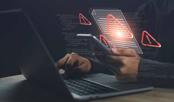istock Cyber Threat Alert. Protect Against Scams, Fraud, and Hacks. Computer security, breach prevention, and warnings to safeguard against viruses, hackers, and digital crime. 2192489876