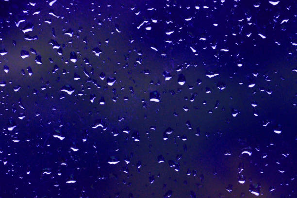 Water drops slide down the blue surface.