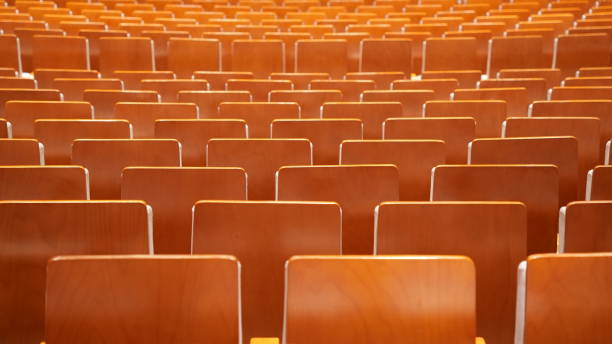 istock Rows of wood board chairs in an auditorium 2192491908