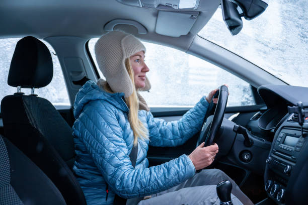 istock Woman driving a car with a frosty window. 2192492404