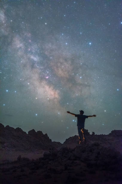 istock Dreamy sky and people looking up at the stars 2192495127